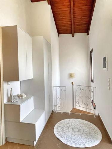 a room with white walls and a white rug at Kathiana cozy apartment in Kathiana