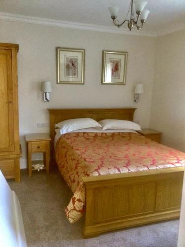 a bedroom with a large bed with two pillows at HENWICK HOUSE Beautiful flat,Private parking, short walk to town in Ludlow