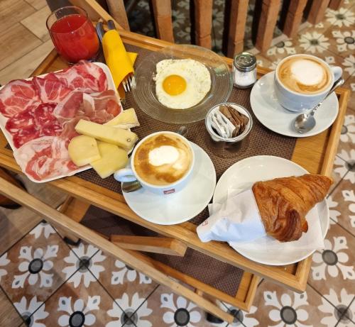 a table with breakfast foods and coffee on it at Antica Piacenza in Piacenza