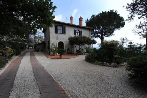 a house with a gravel driveway in front of it at Il Casale in Formia