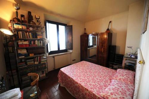 a bedroom with a bed and a window and a book shelf at Il Casale in Formia