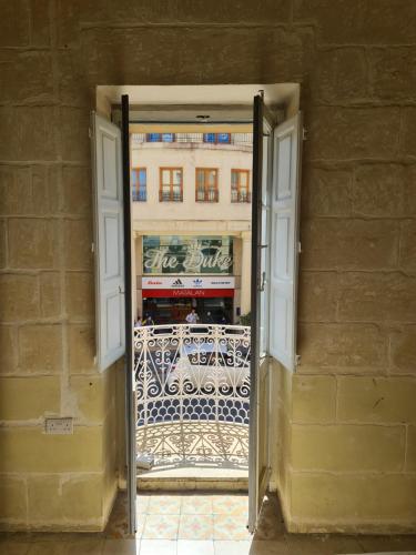 an open door to a balcony with a building at District in Victoria
