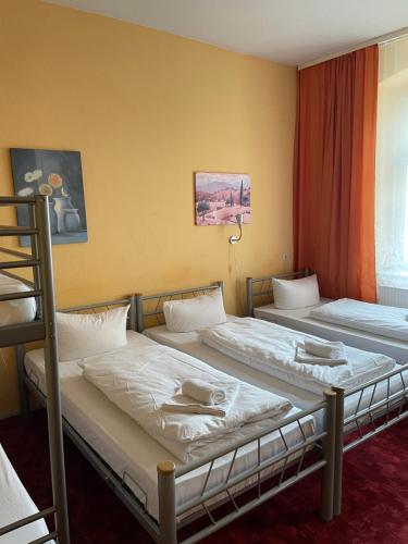 2 Einzelbetten in einem Zimmer mit Fenster in der Unterkunft Hotel Pension Streuhof Berlin in Berlin
