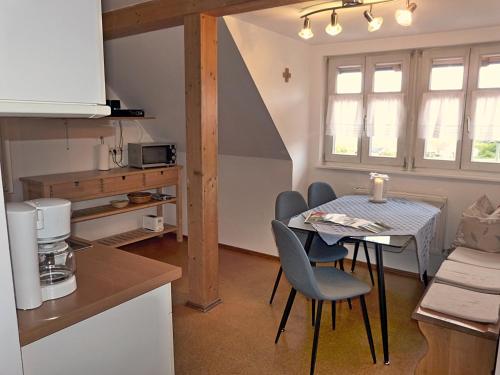 a kitchen with a table and chairs in a kitchen at Landurlaub Wittmann in Pegnitz