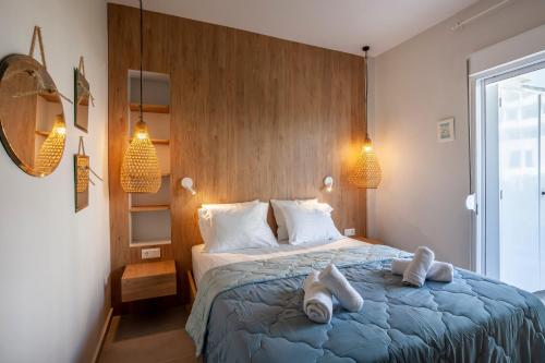 a bedroom with a bed with two towels on it at Calypso beach front apartment in Hanioti