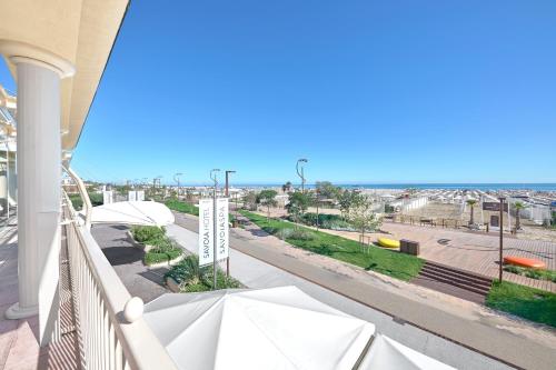 a balcony with a view of a street and the ocean at Savoia Hotel Rimini in Rimini