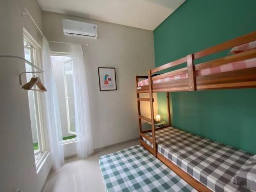 ein Schlafzimmer mit einem Etagenbett mit einem karierten Boden in der Unterkunft Austinville 3BR residential home with backyard. in Kasri