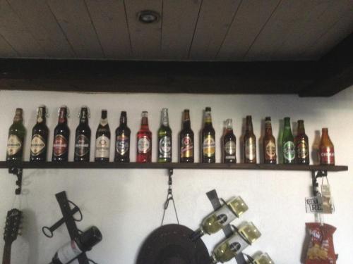 a wall with a bunch of bottles on a wall at Gamla Bryggeriet Bed & Breakfast in Köpingsvik