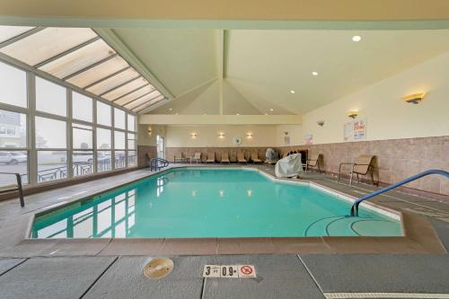 a swimming pool in a hotel with a large window at Best Western Plus Northwoods Inn in Crescent City