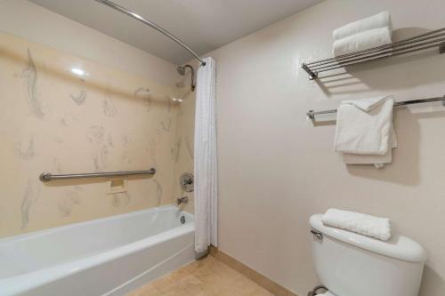 a bathroom with a toilet and a tub and a sink at Best Western Plus Northwoods Inn in Crescent City