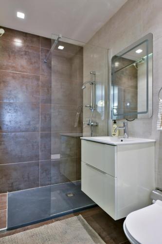 a bathroom with a shower and a sink and a toilet at Mimosa Residenza in St. Julianʼs