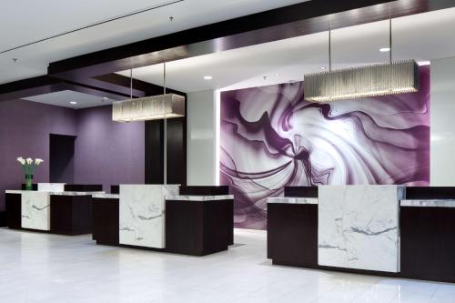 a lobby with purple walls and marble counters and a mural at Hyatt Regency Boston in Boston