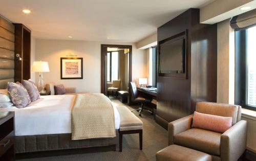 a hotel room with a bed and a desk at Hyatt Regency Boston in Boston
