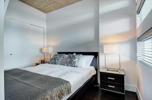 魁北克市的住宿－Les Immeubles Charlevoix - Le 760431，一间卧室配有一张大床和镜子