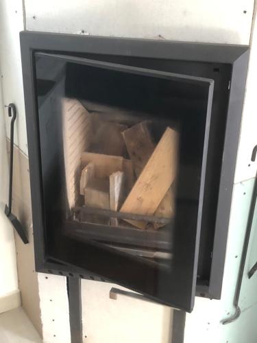 a black oven with a pile of boxes inside at DIAMOND Stone Wooden Guest House in Khandria