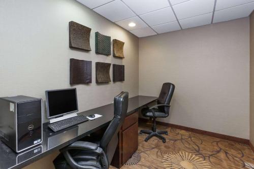 an office with a desk with a computer and two chairs at Super 8 by Wyndham Atoka in Atoka