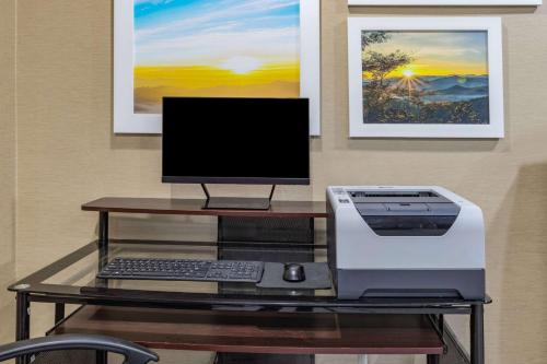a desk with a computer and a printer at Days Inn & Suites by Wyndham San Antonio near Frost Bank Center in San Antonio