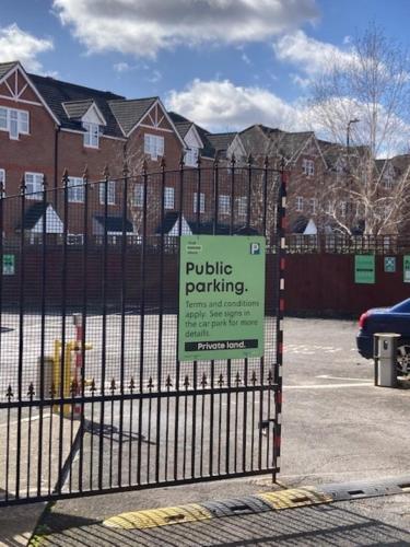 a sign on the gate of a fence at Best Western Northfields Ealing Hotel in London