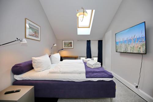 Un pat sau paturi într-o cameră la Villa Greif Wohnung 05