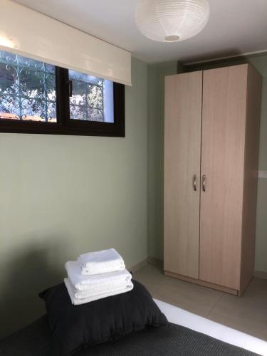 a bedroom with a bed and a cabinet with towels on it at DIAMOND Stone Wooden Guest House in Khandria