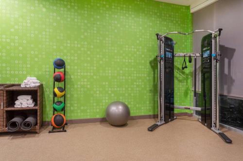 a gym with a green wall and two tread machines at La Quinta Inn & Suites by Wyndham Galt Lodi North in Galt