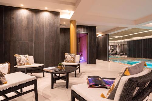a lobby with chairs and a swimming pool at Hotel Yac Paris Clichy, a member of Radisson Individuals in Clichy