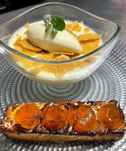 a glass bowl of food on a plate with a piece of food at Craig-y-Dderwen Riverside Hotel in Betws-y-coed