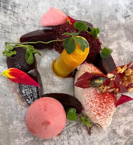 a plate of food with pink desserts on it at Craig-y-Dderwen Riverside Hotel in Betws-y-coed