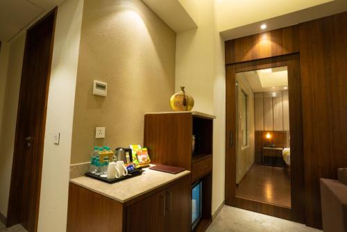 a room with a kitchen with a counter and a hallway at Ratnamouli Palace in Guwahati