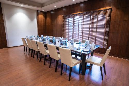 a large dining room with a long table and chairs at Ratnamouli Palace in Guwahati