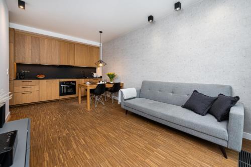 a living room with a couch and a table at Baltiq Plaza - BillBerry Apartments in Gdynia