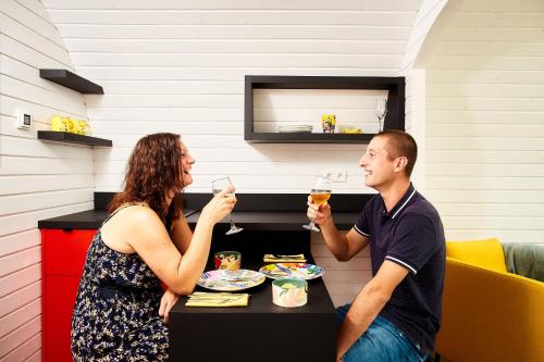 a man and a woman sitting at a table with wine glasses at Au Vieux Moulin in Roy-Boissy