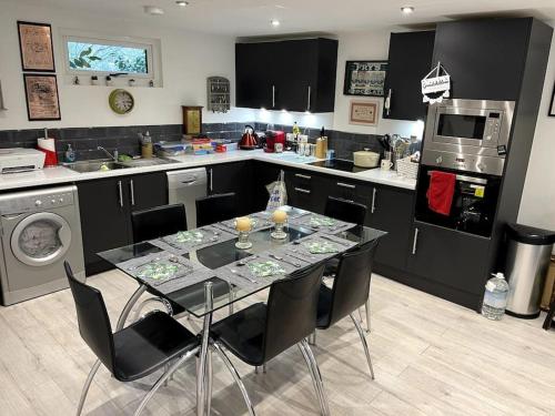 a kitchen with a table and chairs in a kitchen at The Cabin, Arkley, Barnet in Barnet