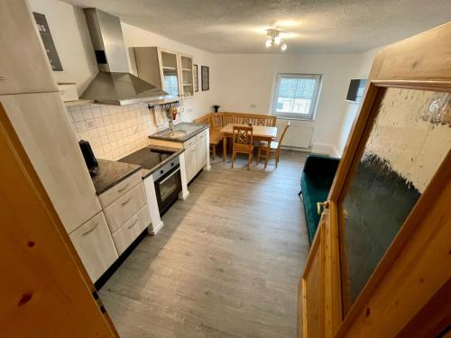 a kitchen with white cabinets and a dining room at Ferienwohnung Melise in Reutte