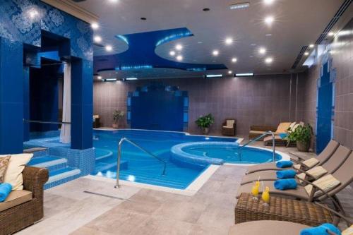a large swimming pool in a hotel room at Golden Ball Club in Győr