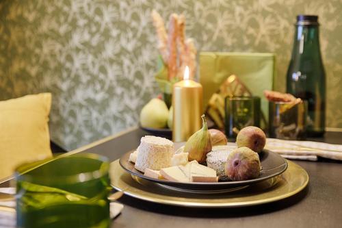 a plate of bread and fruit on a table at Chase Apartments-Boutiquehotel Style II in Würzburg