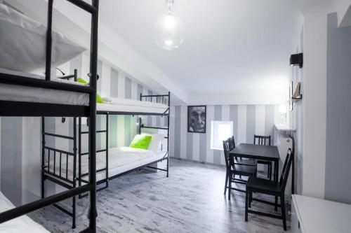 a room with two bunk beds and a table at AB Hostel in Warsaw