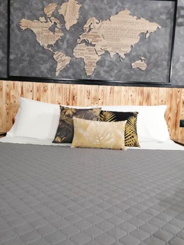 a bedroom with a bed with a world map on the wall at La Dimora del Principe-Piano terra in Trani