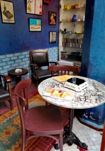 a room with a table with a book on it at Les Bains de Fez Tara in Fès