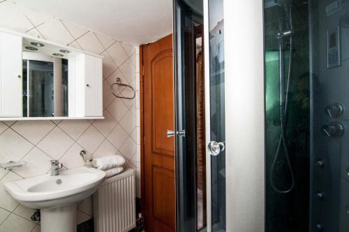 a bathroom with a sink and a shower at Blue Villa 1 - With Private Pool in Perama