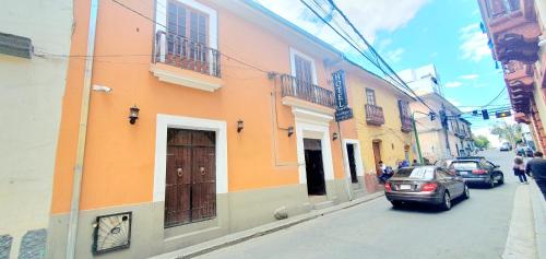 a street with cars parked on the side of a building at Hotel Boutique Vivenzo in La Paz