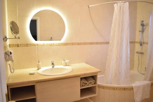 a bathroom with a sink and a shower with a mirror at Aqaba Escape 1 in Aqaba
