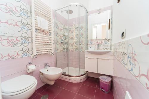 a bathroom with a toilet and a shower and a sink at La Casa di Aurora in Maiori