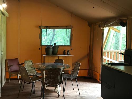 a dining room with a table and chairs at de Swaenhoeve in Zoersel