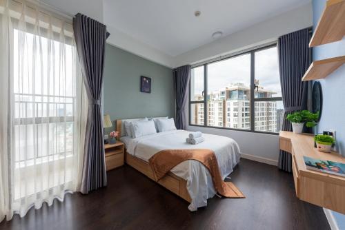 a bedroom with a bed and large windows at REM Rivergate Garden Pool Signature - Free 4G sim for 3 Nights Booking in Ho Chi Minh City