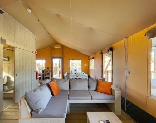 a living room with a couch and a table at Kuanza Farmhouse and Lodge in Zambujeira do Mar