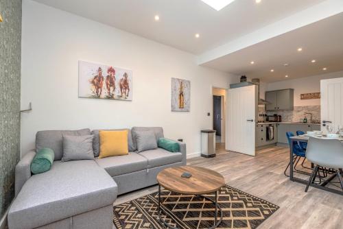 a living room with a couch and a table at The Cotswold Woodland by Fortuna Property Portfolio in Cheltenham