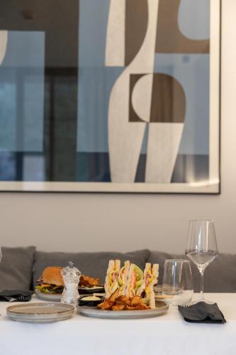 a table with two plates of food and wine glasses at Neoma in Athens