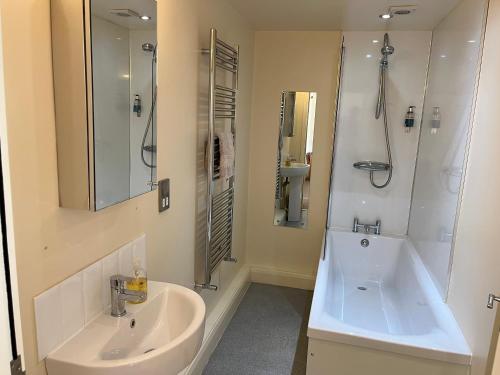 a white bathroom with a sink and a shower at Wold Escapes, Highfield Farm in Great Driffield