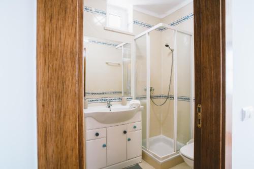 a bathroom with a sink and a shower at Best Houses 52 - Baleal Surfside in Ferrel